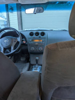 Interior view of a 2012 Nissan Altima 2.5 with well-maintained features and clean dashboard.