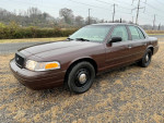 2008 Ford Crown Victoria P71 Police Interceptor with 101,000 miles, in brown color, parked outdoors.