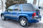 2006 Chevrolet TrailBlazer parked on a snowy road, showcasing its blue exterior and clean condition.