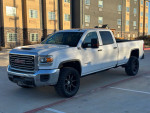 2018 GMC Sierra 2500HD TurboDiesel truck parked, featuring a sleek white exterior and black alloy wheels.