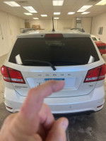 Rear view of a 2014 Dodge Journey R/T in pearl white, showcasing modern SUV design features.