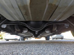 Underside view of a 1968 Plymouth GTX with custom features and exhaust system, showcasing its classic design.