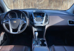 Interior view of a well-maintained 2015 Chevrolet Equinox LTZ with modern dashboard and infotainment system.