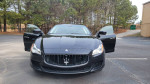 2014 Maserati Quattroporte S Q4 in black with open doors, showcasing luxury design and spacious interior.
