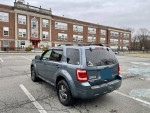 2011 Ford Escape XLT FWD parked in a lot, showing exterior design and new all-season tires.