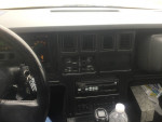 Interior view of a 1989 Corvette convertible showing dashboard, controls, and accessories for sale.