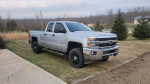 2015 Chevrolet Silverado 2500 HD LT truck parked on grass with an off-road design and towing package features.