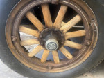 Close-up of a vintage 1928 Dodge Brothers sedan wheel with wooden spokes and original tire.