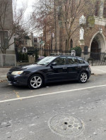 2009 Subaru Impreza Outback Sport parked on a city street, showcasing its sleek design and sturdy build.