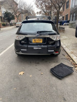 2009 Subaru Impreza Outback Sport parked on the street with low mileage and visible rear features.