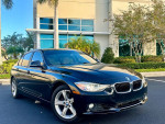 Clean 2014 BMW 328I in black parked outside, featuring 103k miles and a well-maintained exterior.