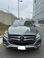 Front view of a 2018 Mercedes-Benz GLE 350 4MATIC in gray, showcasing its elegant design and premium features.