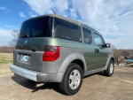 Clean 2003 Honda Element parked outdoors, showcasing its green exterior and modern design.