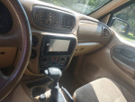 Interior of a 2003 Chevy Trailblazer 4x4, featuring clean upholstery and a modern dashboard with a screen.