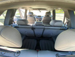 Interior view of a 2015 BMW X5 M showing spacious 3rd row seating and luxurious black leather trim.
