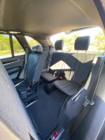 Interior view of the 2015 BMW X5 M with black leather seats and spacious third row.