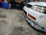 1994 Honda Accord coupe in a garage with aftermarket front bumper and tools in the background, ideal project car.