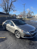 2010 Volkswagen CC in silver, parked with clear skies and trees in the background, great for everyday commuting.