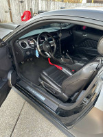 Interior view of a 2013 Ford Mustang GT Premium showcasing black leather seats and detailed dashboard.