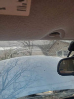 Interior view of a Chevrolet TrailBlazer with a cracked windshield, highlighting the SUV's dashboard and condition.