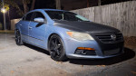 2010 Volkswagen CC Sport in blue with carbon fiber accents and black rims, parked at night