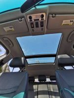 Interior view of a 2011 BMW 3 Series showing panoramic sunroof and spacious seating for families.