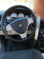 Interior view of a 2010 Dodge Grand Caravan SXT with a steering wheel and dashboard