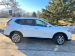 2015 Nissan Rogue SL in white, showcasing modern design and features like a panoramic sunroof and keyless entry.