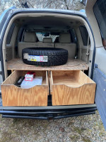 2006 Lexus GX 470 interior with storage drawers and spare tire. Equipped for outdoor adventures and off-roading.