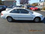 1995 Honda Civic EX in white color, two doors, gray cloth interior, parked at a dealership.