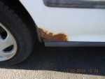 Rust on the rear panel of a 1995 Honda Civic EX, showcasing its age and wear.