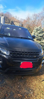 Front view of a 2013 Land Rover Range Rover Evoque in black, showcasing its luxury features and well-maintained exterior.