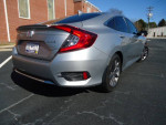 2021 Honda Civic EX in silver, showcasing rear view, parked on asphalt with clear blue sky.