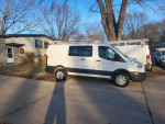 2017 Ford Transit 250 cargo van parked on a residential street, well-maintained and clean.