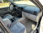 Interior view of a well-maintained 2009 Kia Sorento with 121,000 miles, featuring grey upholstery and modern dashboard.