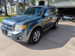 2011 Ford Escape Limited in blue parked outside, showcasing stylish design and chrome wheels.