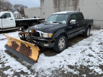 2001 Toyota Tacoma PreRunner with plow in snowy condition, operational with rust and wear details.