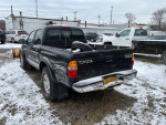 2001 Toyota Tacoma PreRunner RWD parked in snow, showing rust and a functional plow attachment