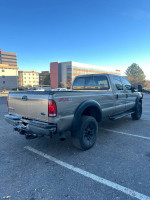 2005 Ford F-350 King Ranch Edition truck in a parking lot, showcasing its rugged design and off-road capabilities
