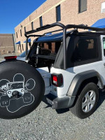 2020 Jeep Wrangler with heavy duty roof rack and upgraded 8.4" radio, showcased from the rear.