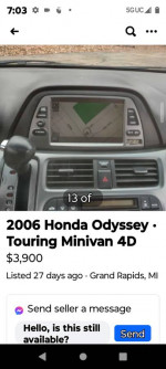 Interior view of a 2006 Honda Odyssey Touring showing navigation system and dashboard features.