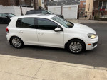 2011 Volkswagen Golf GTI in white, featuring navigation, heated seats, and sunroof, parked on a street.
