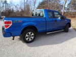 2014 Ford F150 STX extended cab 2WD in blue, displaying a clean and well-maintained exterior.