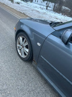 2007 Saab 9.3 parked on the road, showing some rust on the wheel wells and stylish alloy wheels.