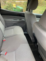 Interior view of 2013 Toyota Tacoma PreRunner showing clean, spacious backseat with gray fabric upholstery.