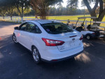 White 2014 Ford Focus parked outdoors, showing minor damage and in good running condition.