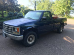 Blue 1993 Chevrolet Pickup truck with alloy rims and tool box, showing wear and low mileage
