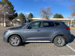 2017 Hyundai Tucson in gray parked, showing side view with some scratches, ideal value SUV with low mileage