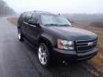 2009 Chevrolet Suburban LTZ 4WD in excellent condition with new paint, 3-row leather seating, and factory wheels.