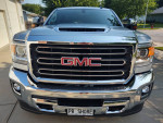 Front view of a 2018 GMC Sierra SLT 3500 HD, showcasing its chrome grill and pristine condition.